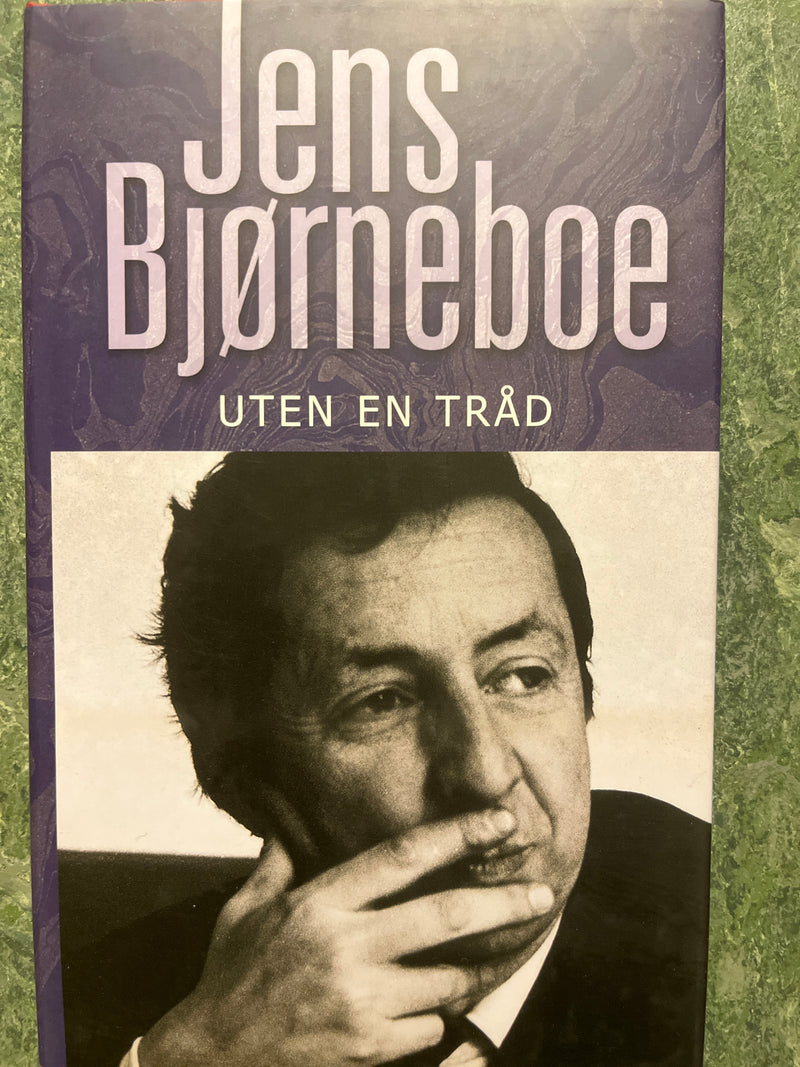 Innbundet bok av Jens Bjørneboe med tittelen "Uten en tråd" fra samling av verker, vist med omslag og tittel på forsiden.