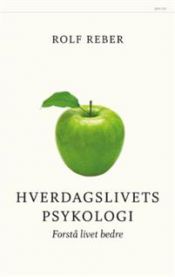 Psykologi bok "Hverdagspsykologi" av Pax med åpen bok og notatark på bordet, viser innholdet i innbundet utgave.