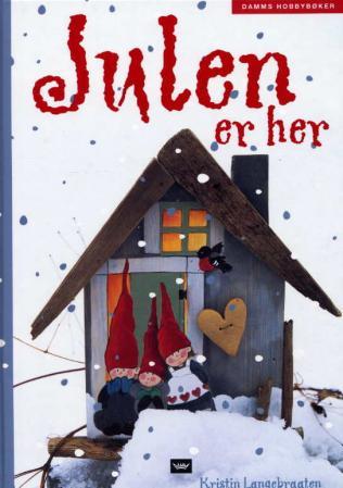 Bokomslag for "Julen er her" av Cappelen Damm AS, en innbundet hobbybok med juletema og festlige illustrasjoner.