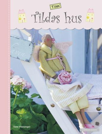 Bokomslag for Tildas hus, en hobbybok utgitt av Cappelen Damm AS, med bilder av et koselig hus i illustrasjon.